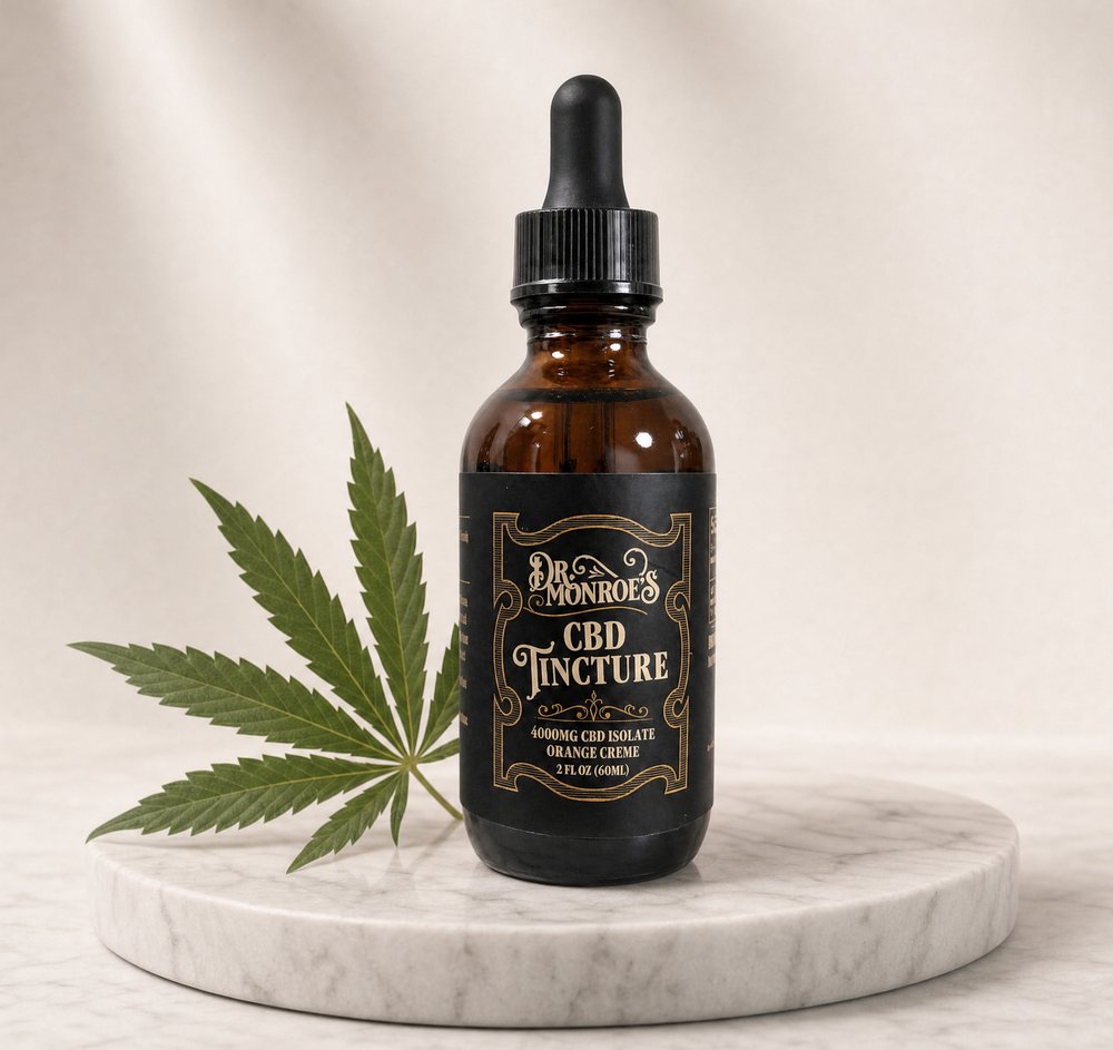 Dr. Monroe's CBD Tincture dropper bottle on a marble pedestal with a hemp leaf